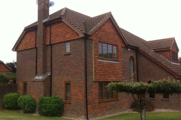 Rosewood fascia and soffit with black guttering