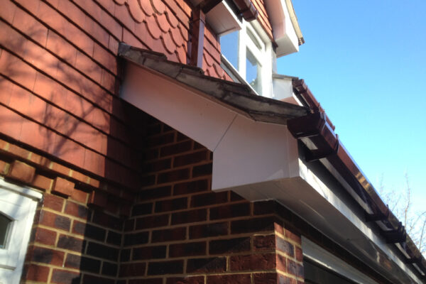 White fascia, soffits and bargeboard with brown square guttering and down pipes