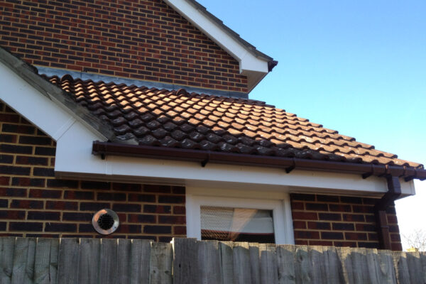 White fascia, soffits and bargeboard with brown square guttering and down pipes